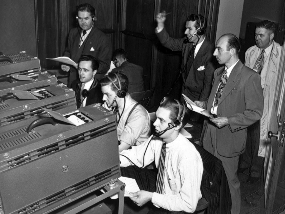 A black and white historical photo of electronics students broadcasting the first live television show in Canada for a general audience
