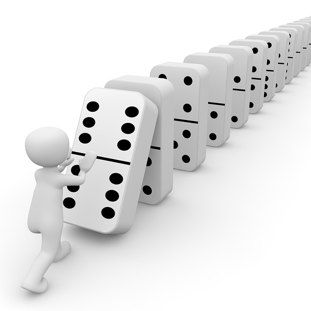 A figure pushing down a line of dice