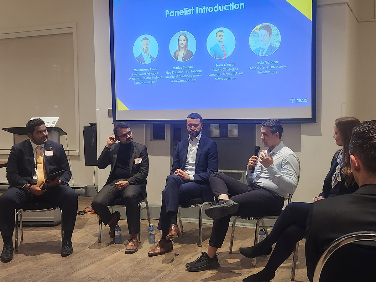 Five panel members with a presentation screen behind them at the SAF information session from TRAIC