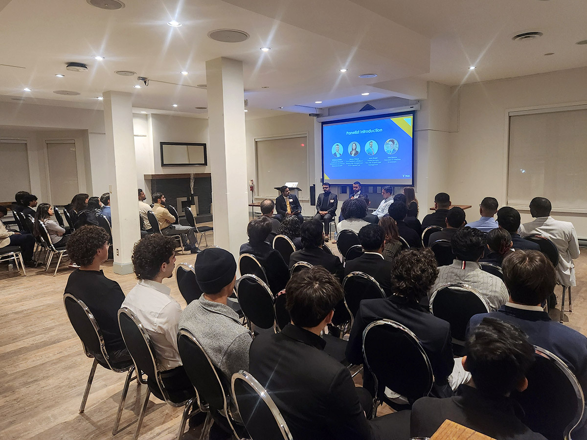 School of Accounting and Finance's information sessions with a photo of panel members from TRAIC and students seating around them, listening and engaged