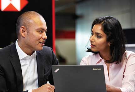 Student at desk with computer getting support from Co-op coordinator