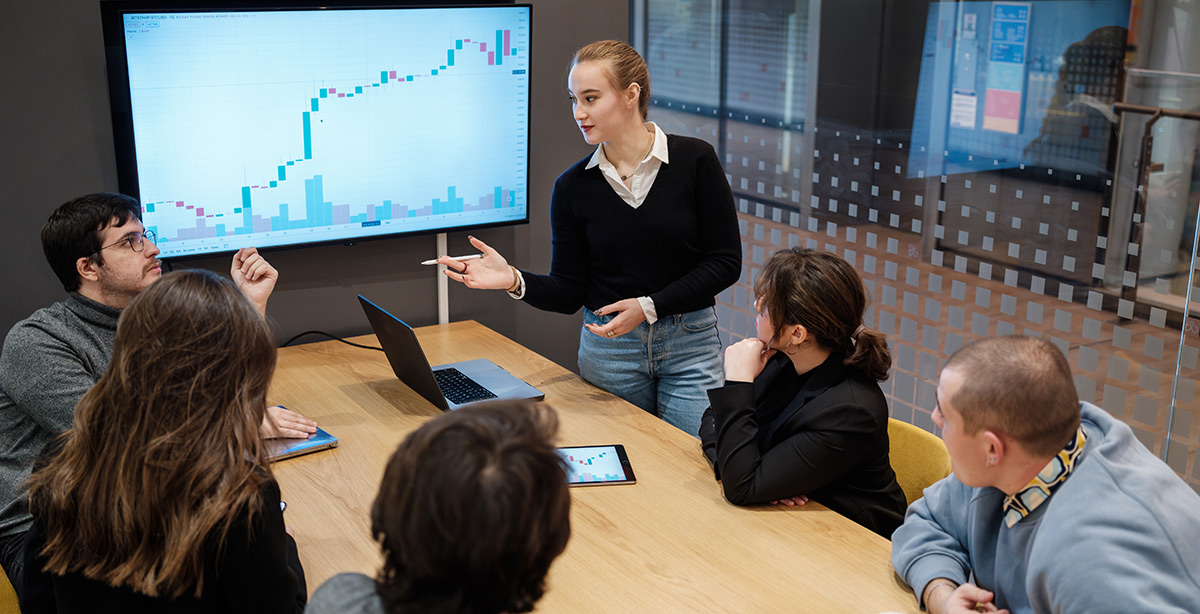 Young business people having stock trading and investing course