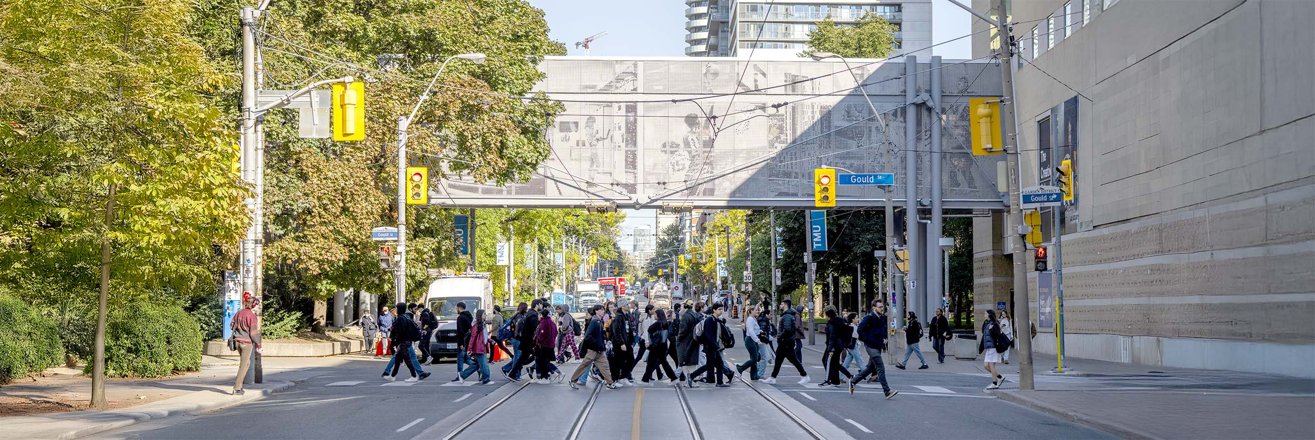 Students crossing the pedestrian crosswalk on campus located at the intersection of Gould Street and Church Street.