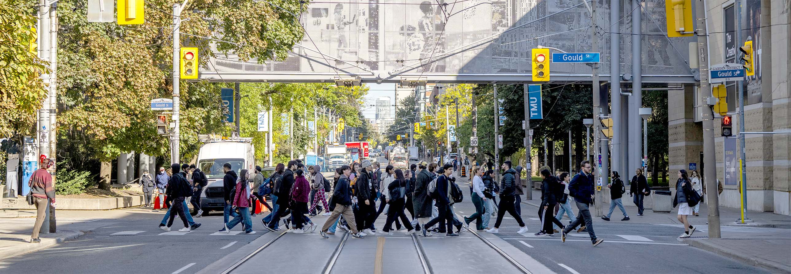 Students crossing the pedestrian crosswalk on campus located at the intersection of Gould Street and Church Street.