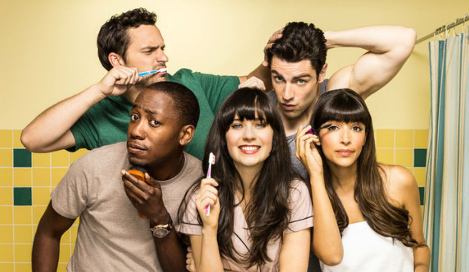The cast of New Girl. Clockwise, from left: Jake Johnson, Max Greenfield, Hannah Simone, Zooey Deschanel, and Lamorne Morris