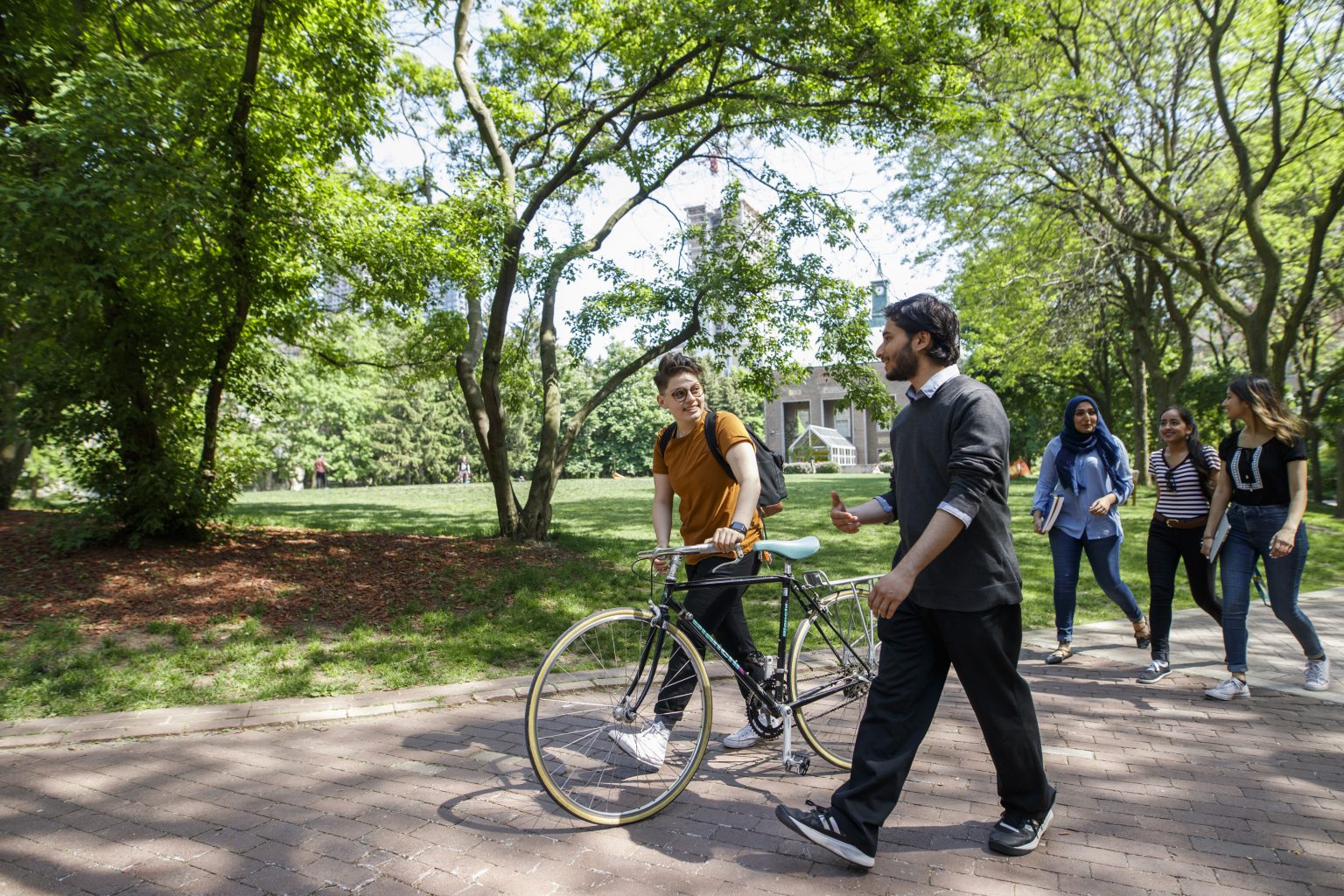 Students walking with bicycle in the Quad on campus