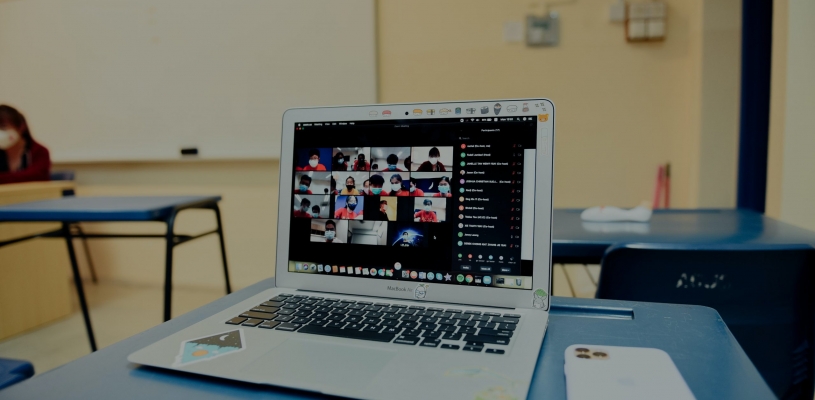 photo of laptop and video call with students in class