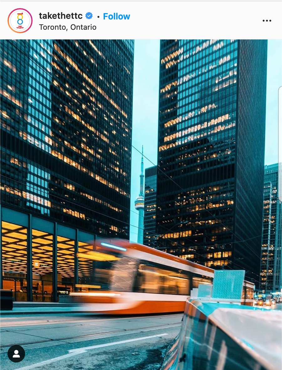 Financial district in Toronto, TTC streetcar moving with the CN tower in the distance.