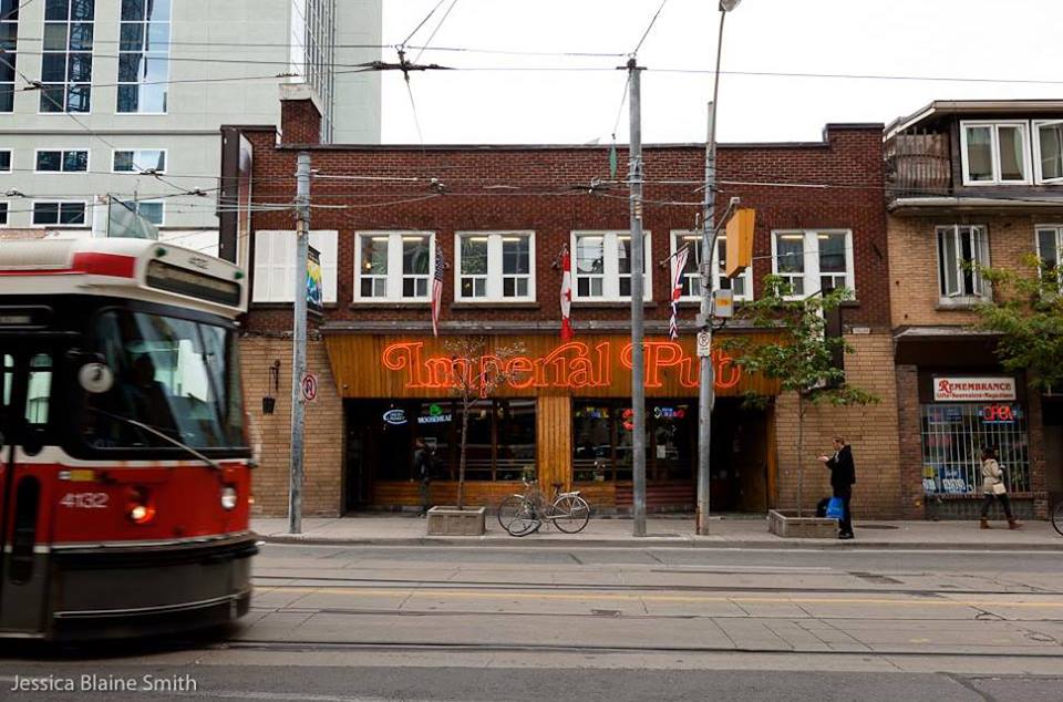 Image of Imperial Pub storefront signage in red neon light
