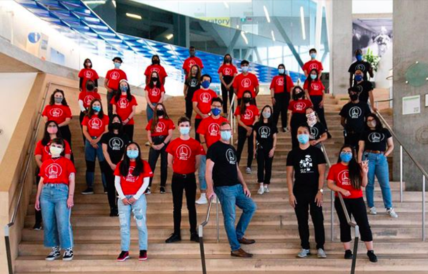 Ryerson's Student Learning Centre staff standing staggered on stairs.