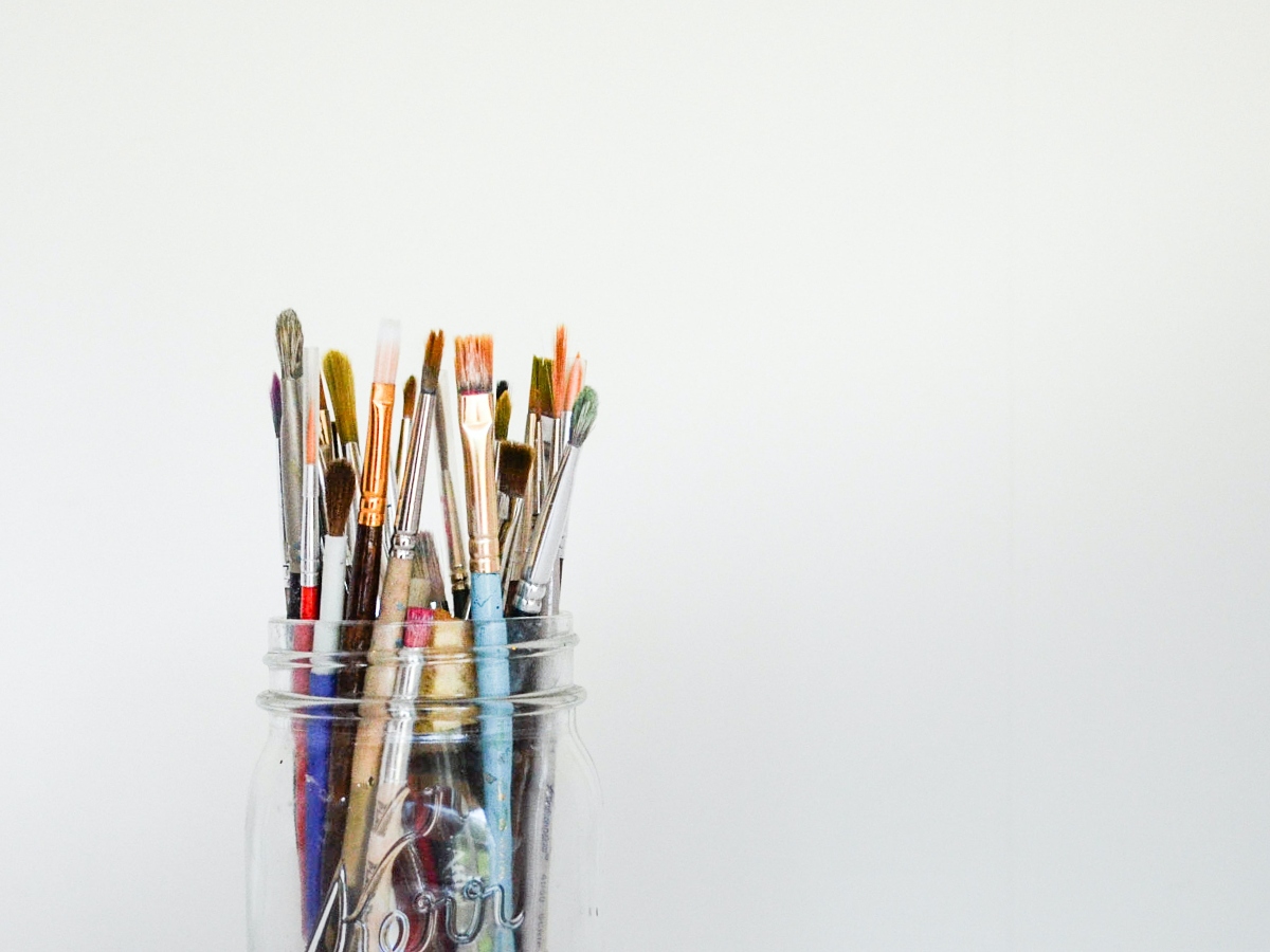 Paint brushes in a glass cup
