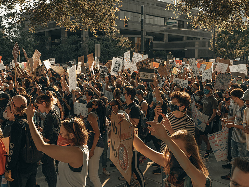 A crowd of protesters line the streets to demand change.
