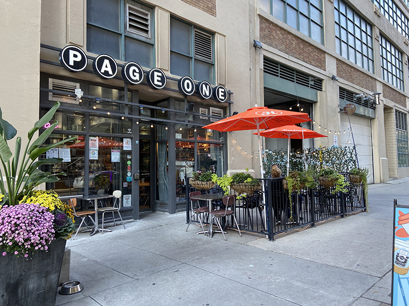 The outdoor patio and entrance of Page One Café is in view on Mutual Street