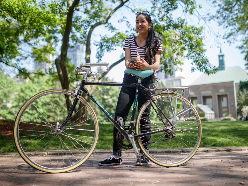 Person leaning on a bike outside