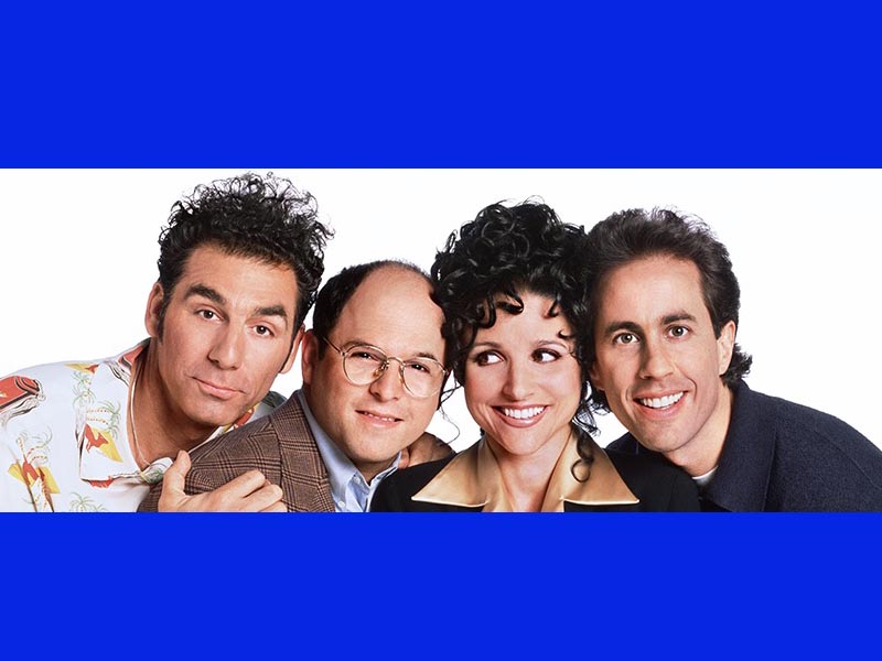 Kramer, George Constanza, Elaine Benes and Jerry Seinfeld smile at the camera for a Seinfeld cast photo.