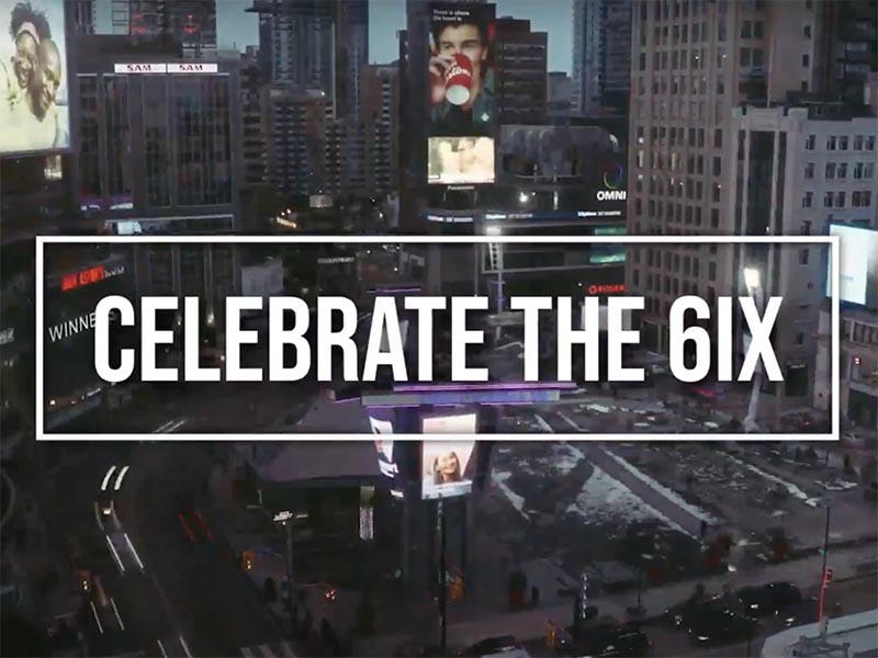 A screenshot from our video pitch, which is a birds-eye view of Yonge-Dundas Square in the evening with "Celebrate the 6ix" in all upper-case white text. 