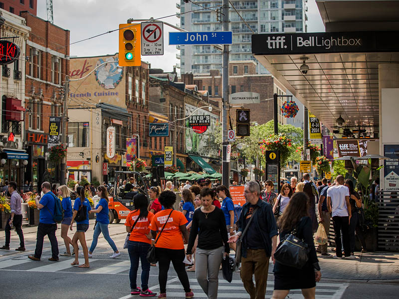 Crowds of people walk around Tiff Bell Lightbox at the corner of King and John Street in anticipation of the festival.