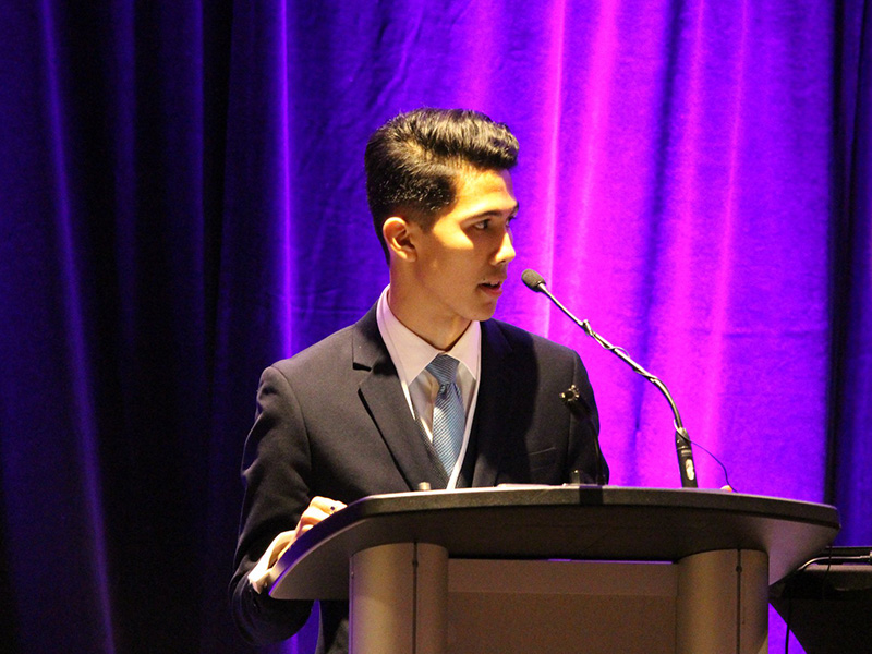 Jeremy delivers a speech at a podium