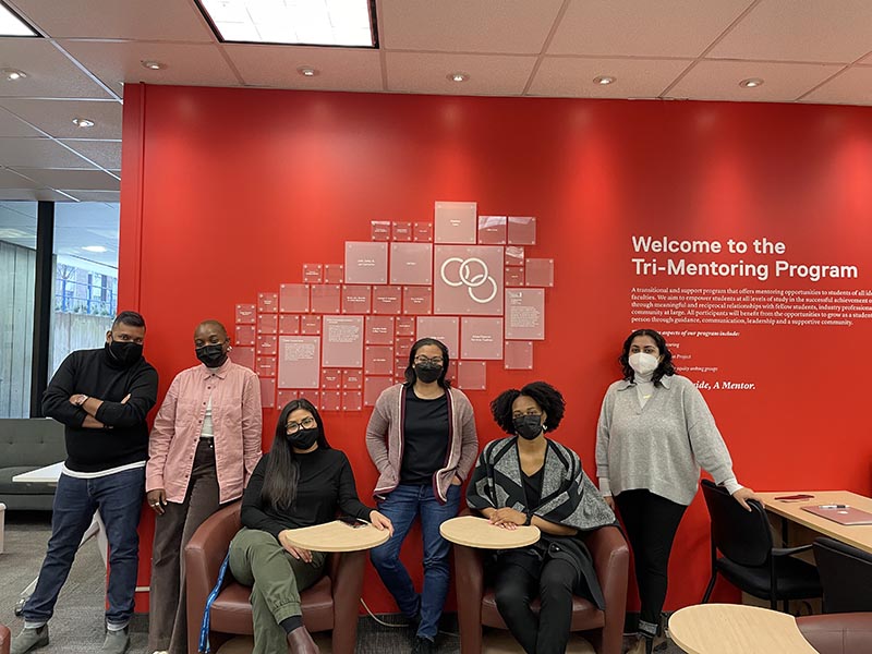 The staff of the Tri-Mentoring Program pose for a photo in their office.