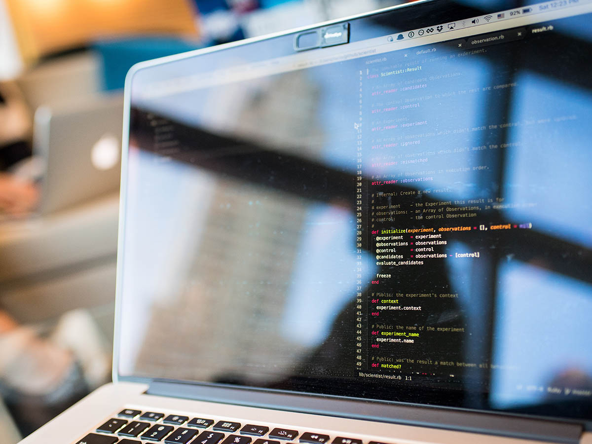 A laptop with programming language on its screen.