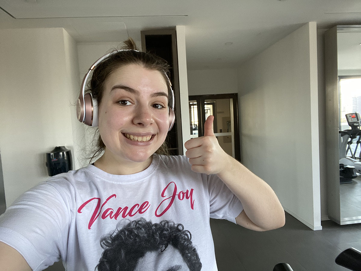 Jenna gives a thumbs-up after completing her workout on the treadmill.