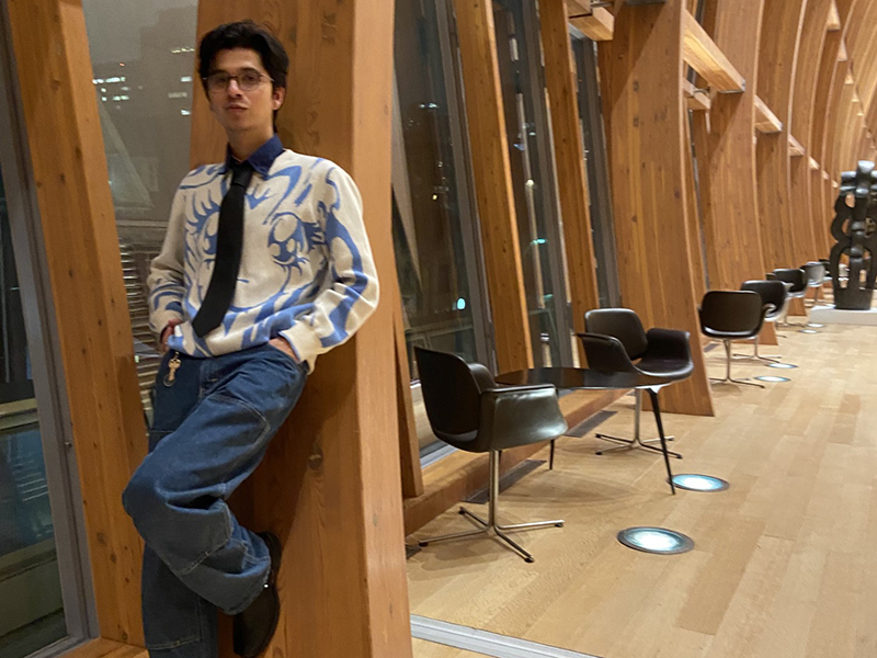 David leans against the wooden window frames at the AGO.