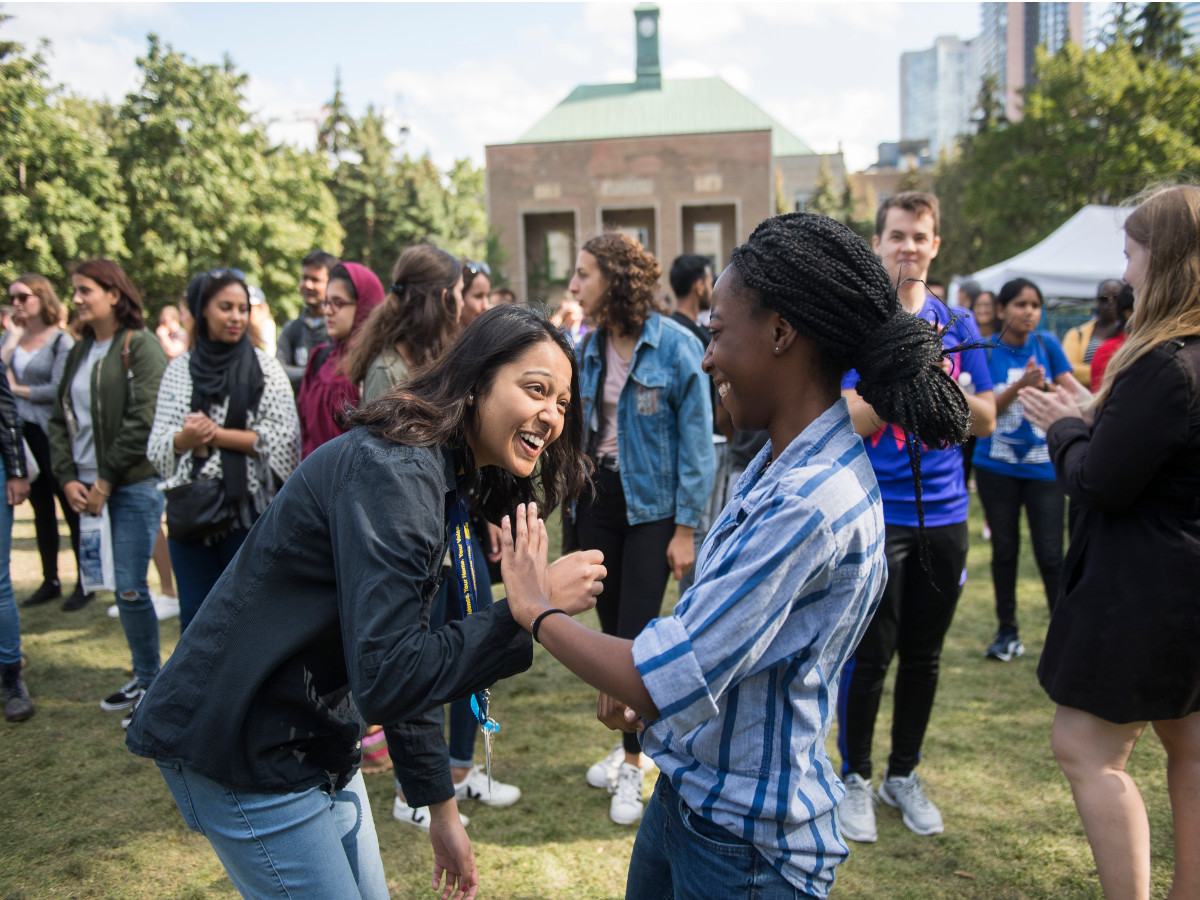 Students laughing as they enjoy an event in the Quad