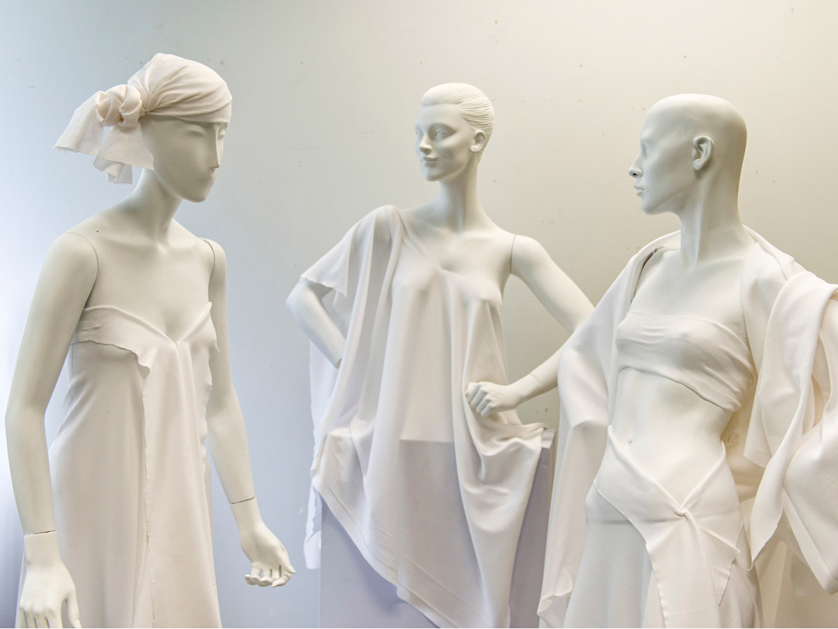 Mannequins draped in various designs using muslin