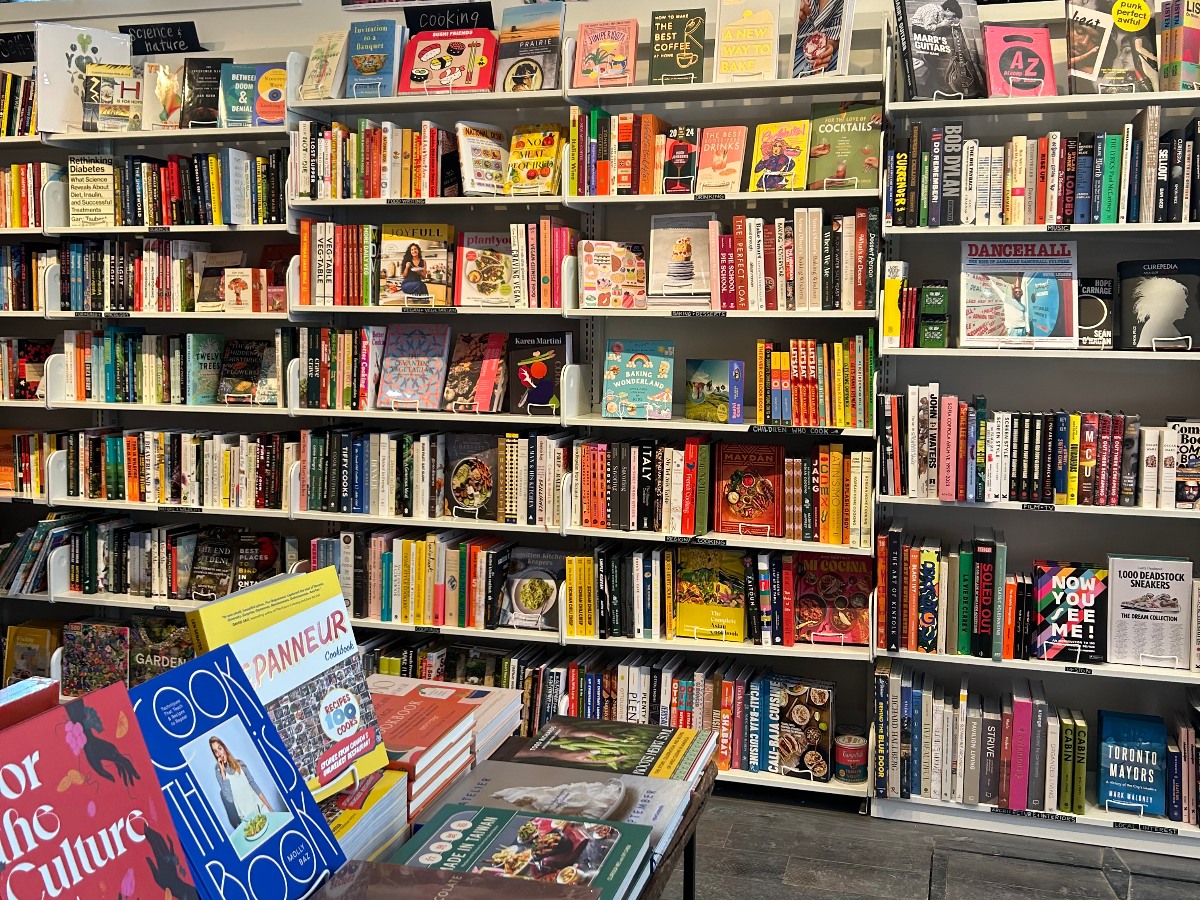 A bookstore is filled with colourful books on the shelves.