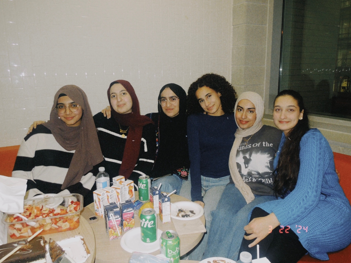 Hadiqah and five of her friends break their fast together around a table full of homemade food.