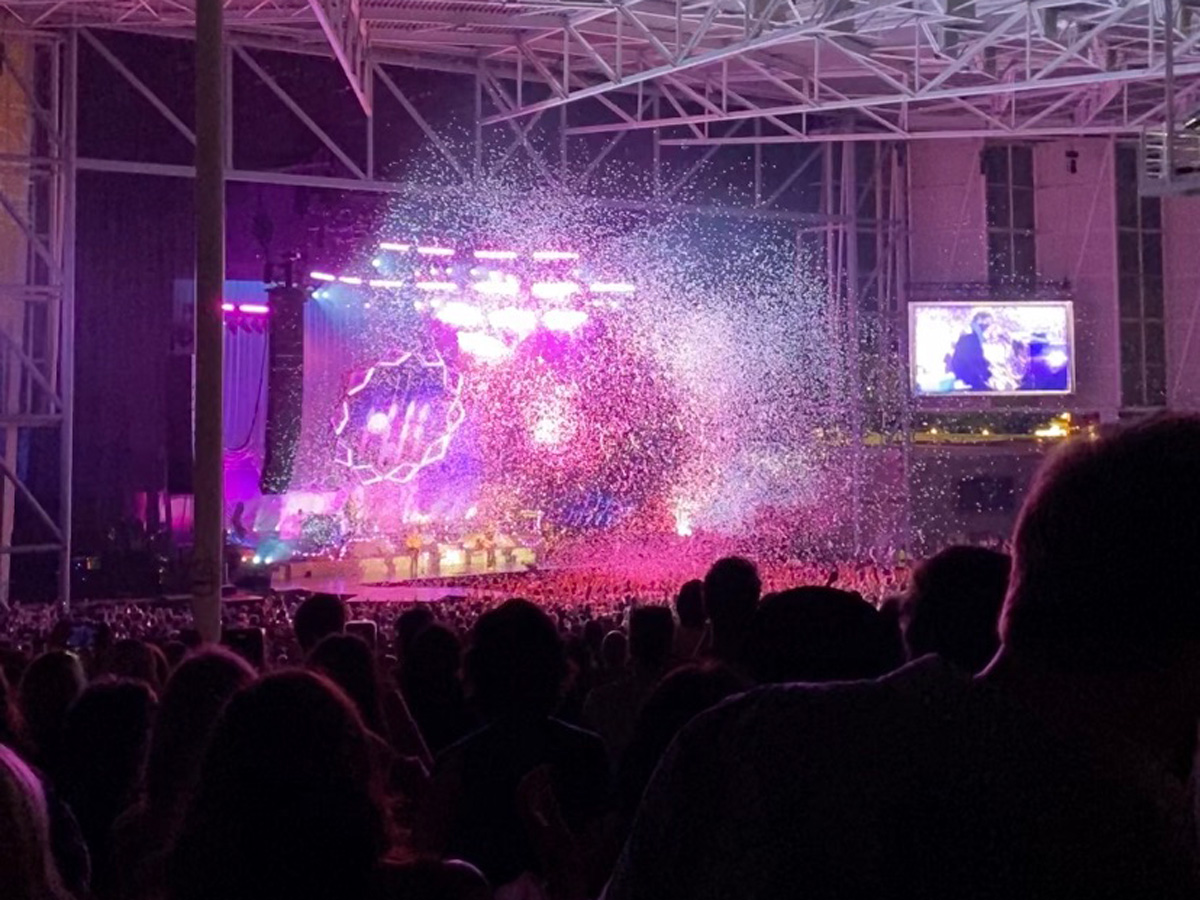 The Lumineers performing alongside bright lights and confetti on Budweiser Stage.