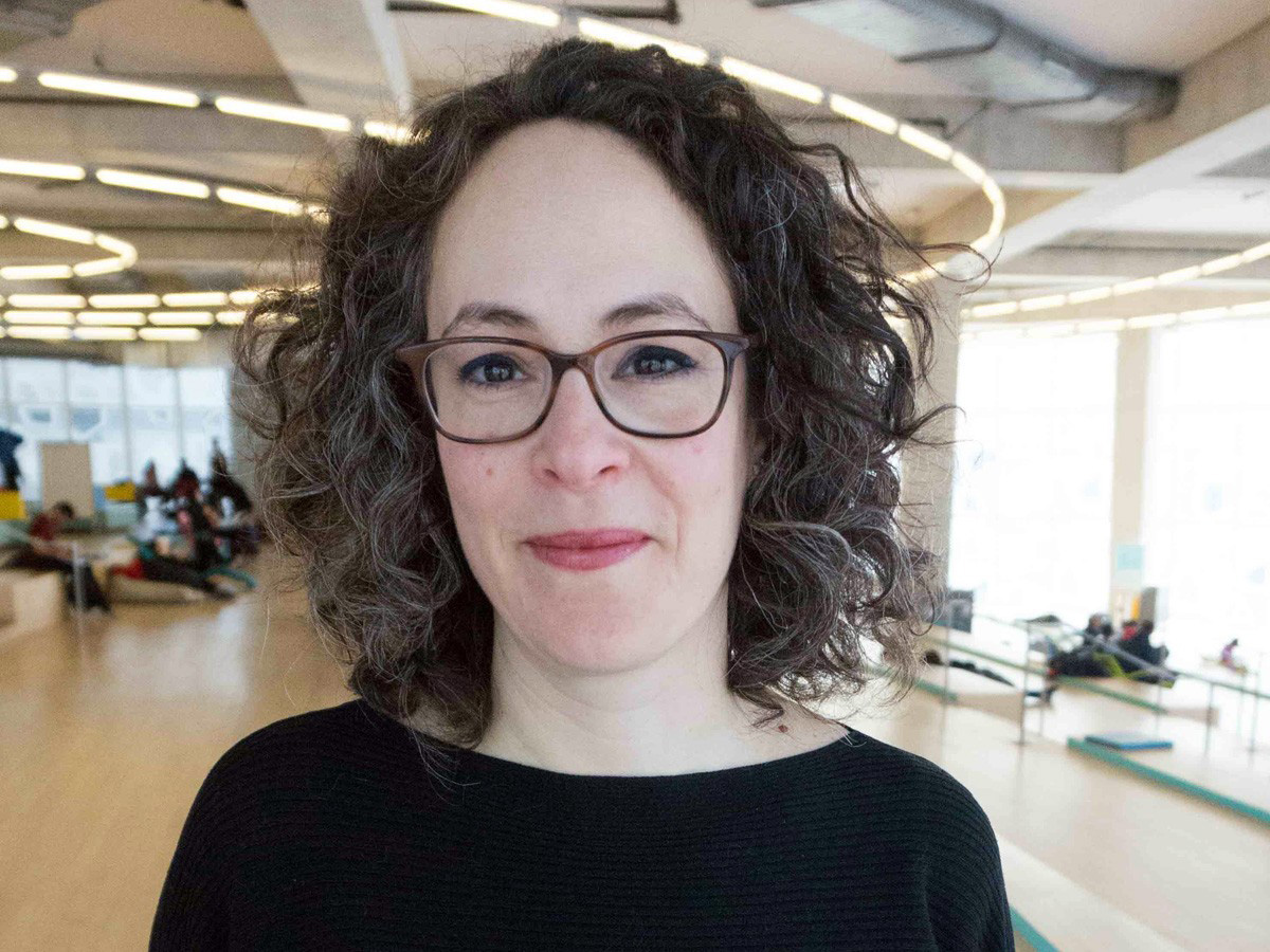 A close-up of Ruth smiling at the camera in the SLC.