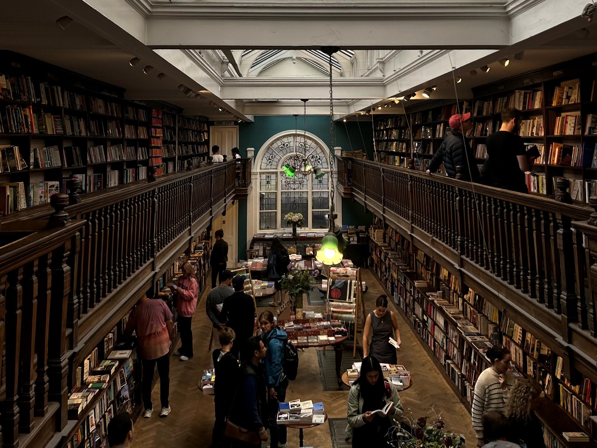 Thousands of books fill the walls of the dark academia Daunt Books store in London, England.
