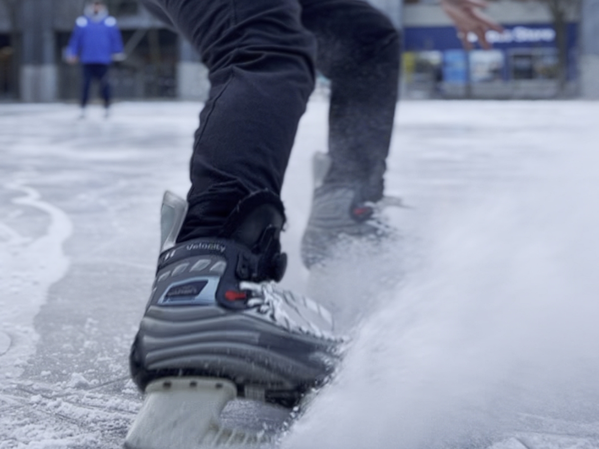 A close-up of Alessandro testing out their TwistLace product on the ice at Lake Devo.