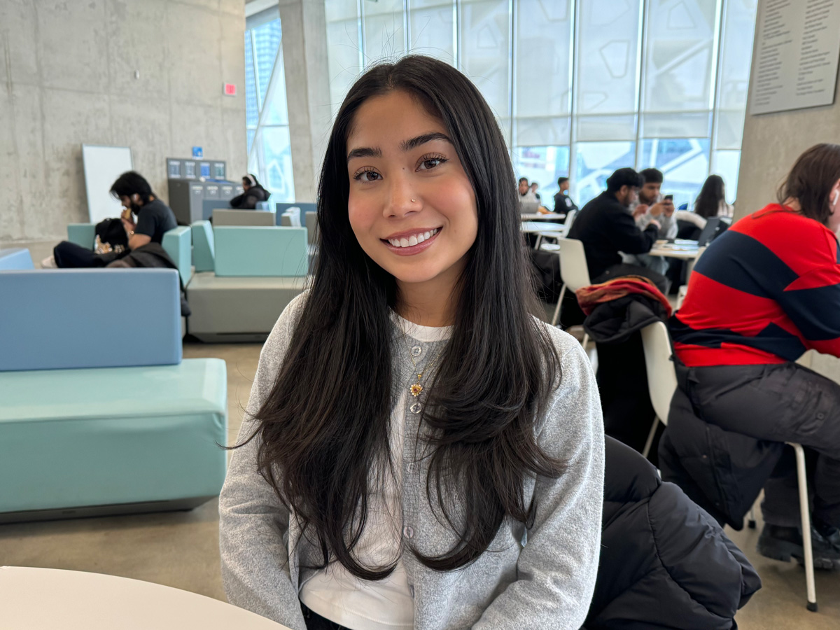 Freshta Wahidulla, a Politics and Governance student sitting at a table in the Student Learning Centre (SLC). 