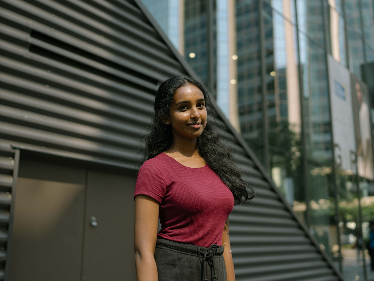 Shaaranki Kulenthirarasa, a Journalism student standing outside of the Ted Rogers School of Management (TRSM) building.