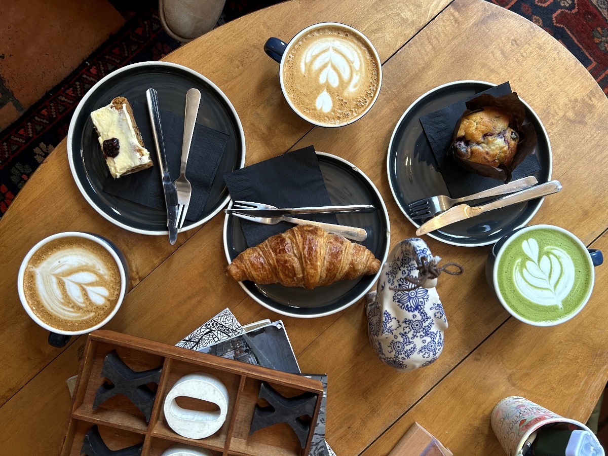 Croissants, coffee and pastries lay on a wooden table in Nabulu.