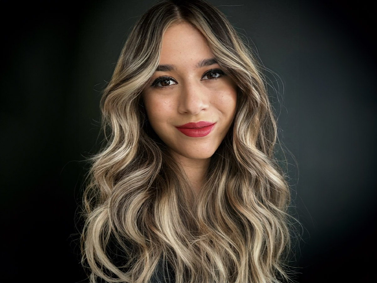 Aliya smiles in a headshot.