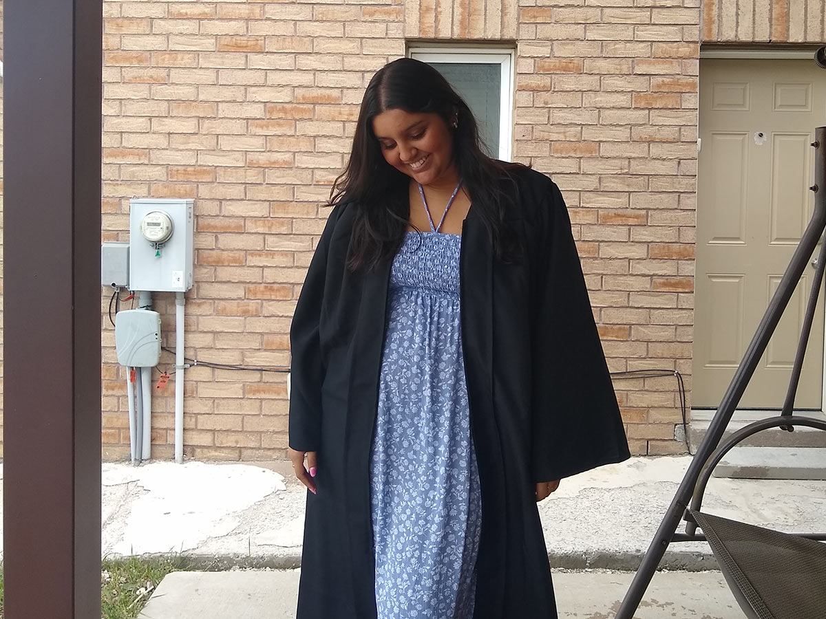 Hiya wearing a graduation gown.