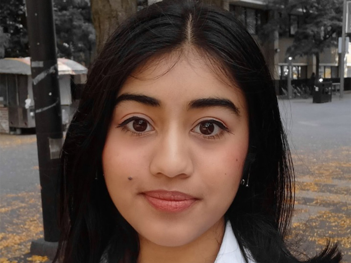 Pri stands on Gould Street and smiles.