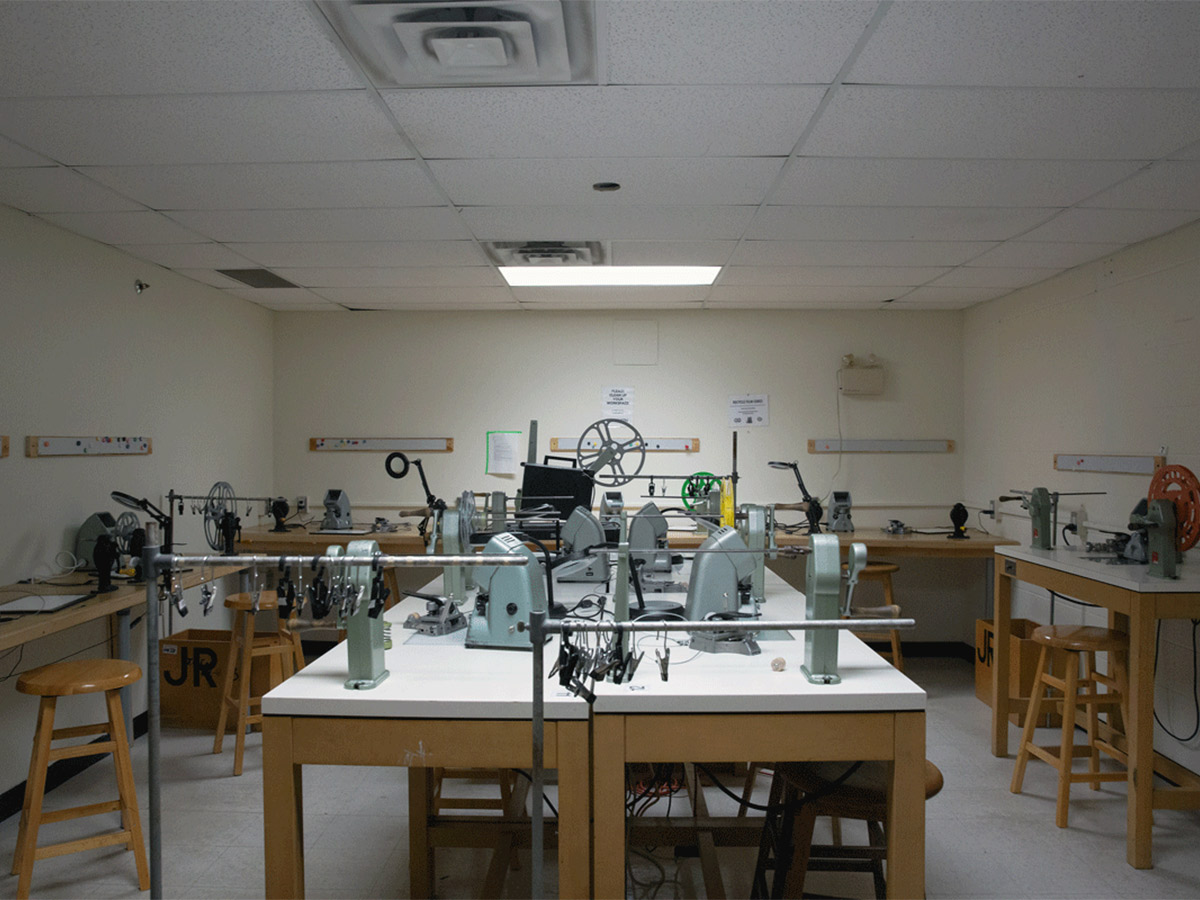 A room in the Image Arts Building with film editing rewind cranks and a projector.