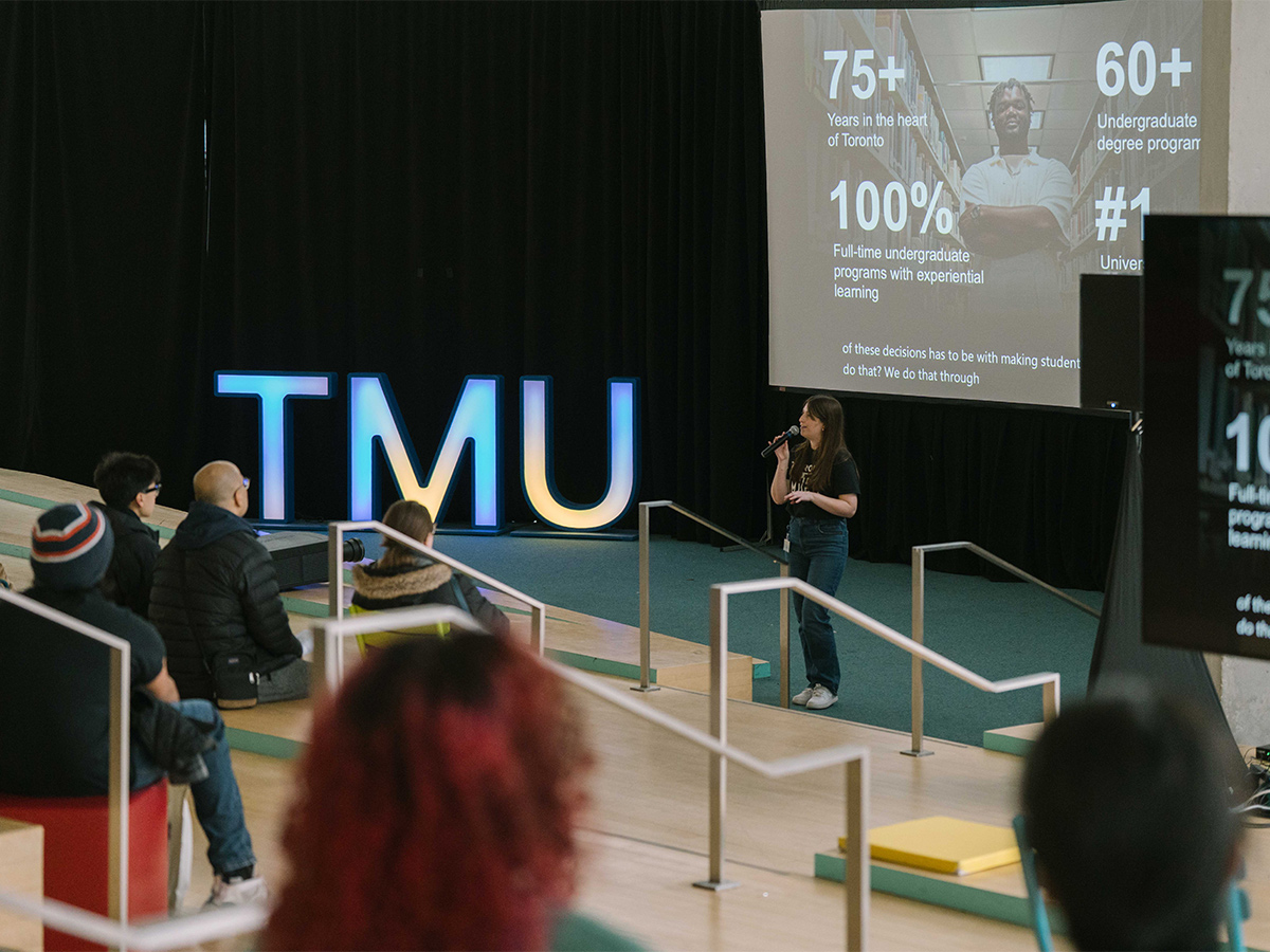 Guests watch a presenter speak at an Open House information session in the Student Learning Centre.