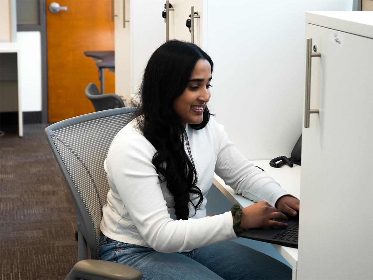 Rishni works from her desk at her office on campus.