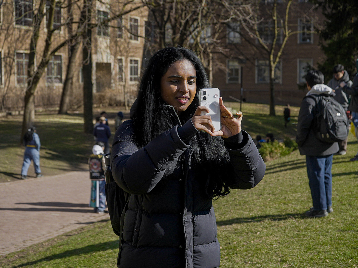Shaaranki photographs content on her phone at Kerr Quad for Engineering's Bug Push event.