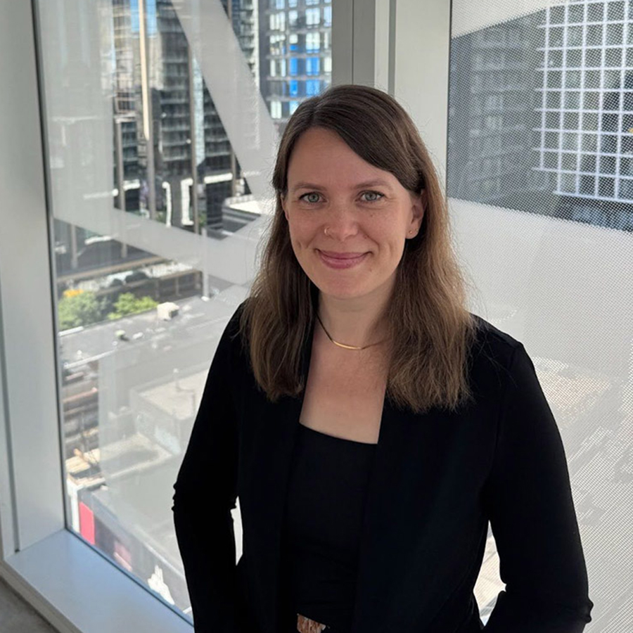 Carly facing the camera smiling for the headshot.