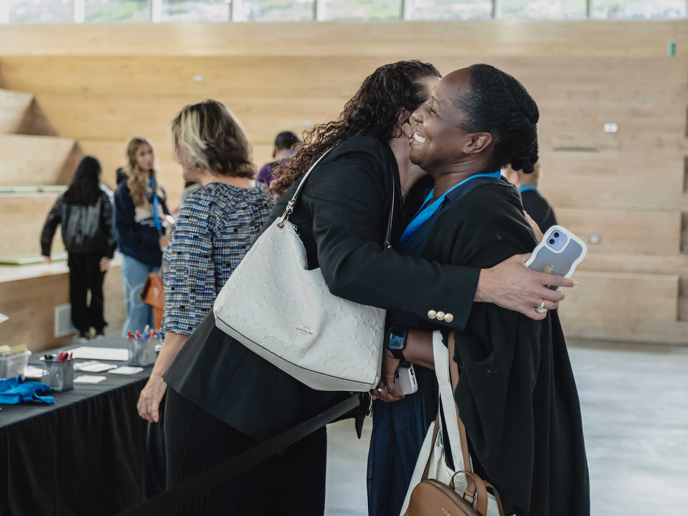 Two alumni share a happy embrace at Alumni Reunion registration