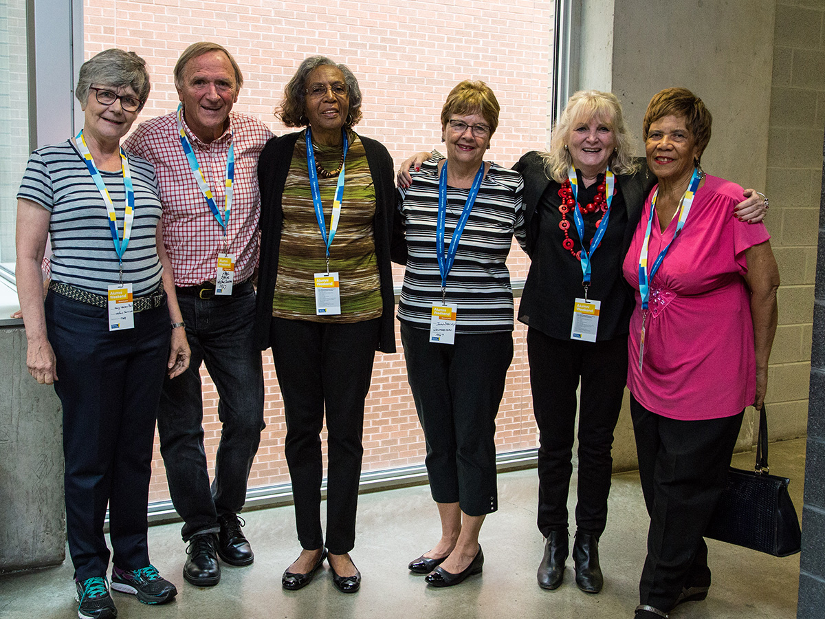 Group of alumnae standing together looking at the camera