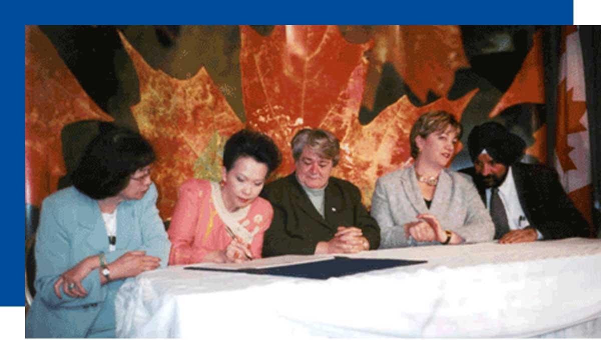Vivienne Poy signing the official declaration to designate May as Asian Heritage Month, in May 2002. (Courtesy of Vivienne Poy)