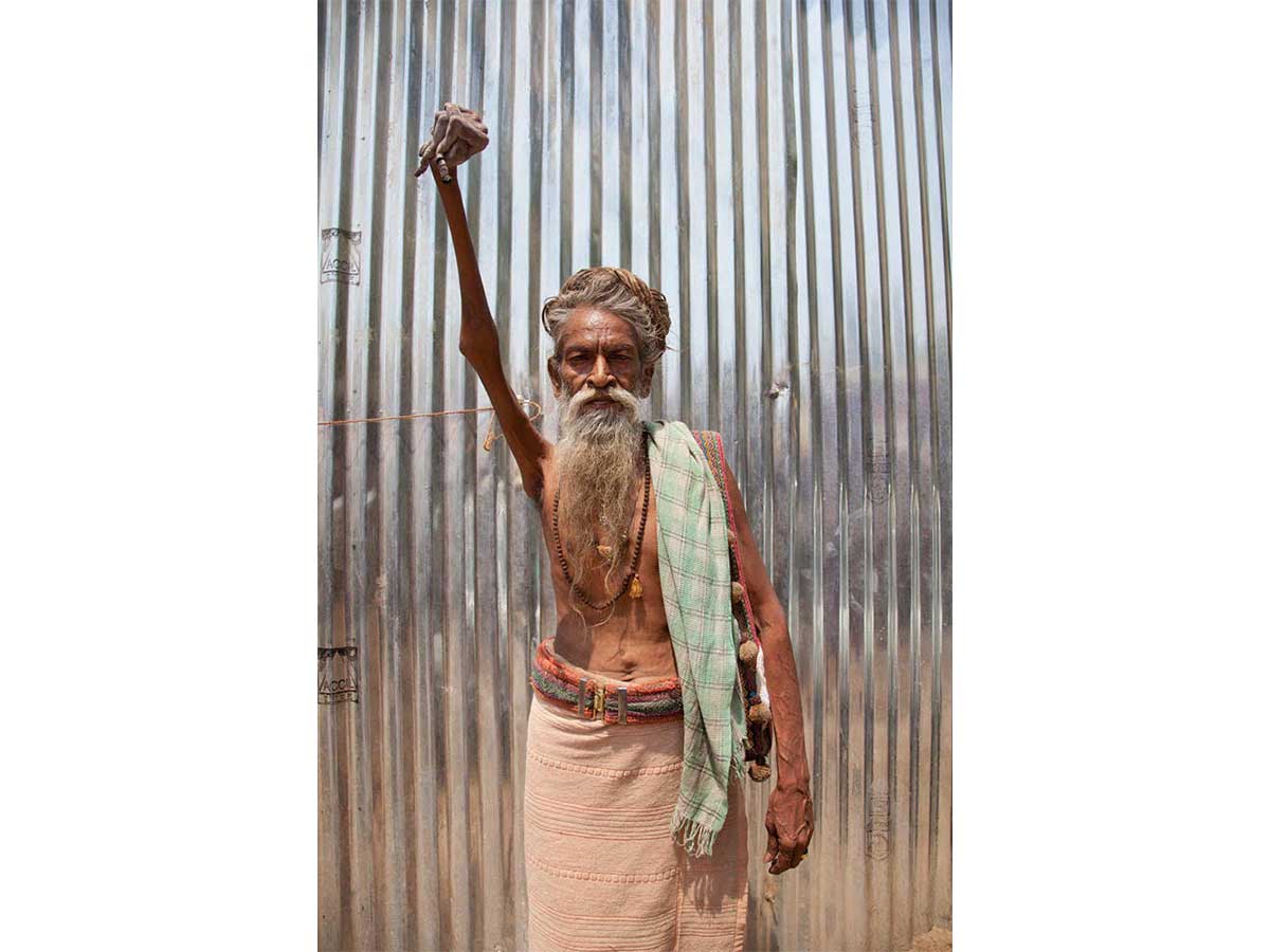 Portrait of Indian sadhu Amar Bharati who has held his arm up in solidarity, for what people say has been 50 years,  in devotion to Shiva and as a call to action for World Peace. Photo by Che Kothari.