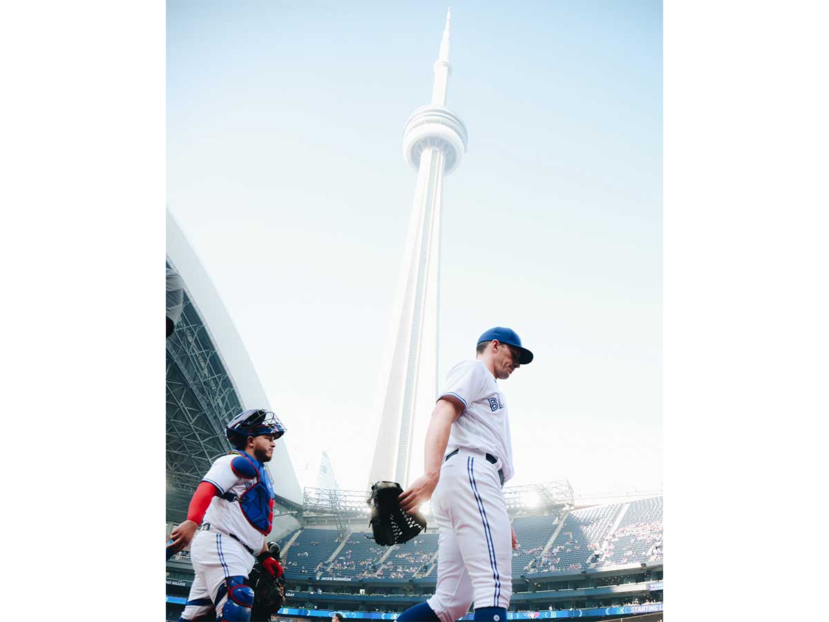 Blue Jays Alejandro Kirk and Chris Bassett walking onto field at Rogers Centre. Photo by Kishan Mistry/UNINTERRUPTED Canada.